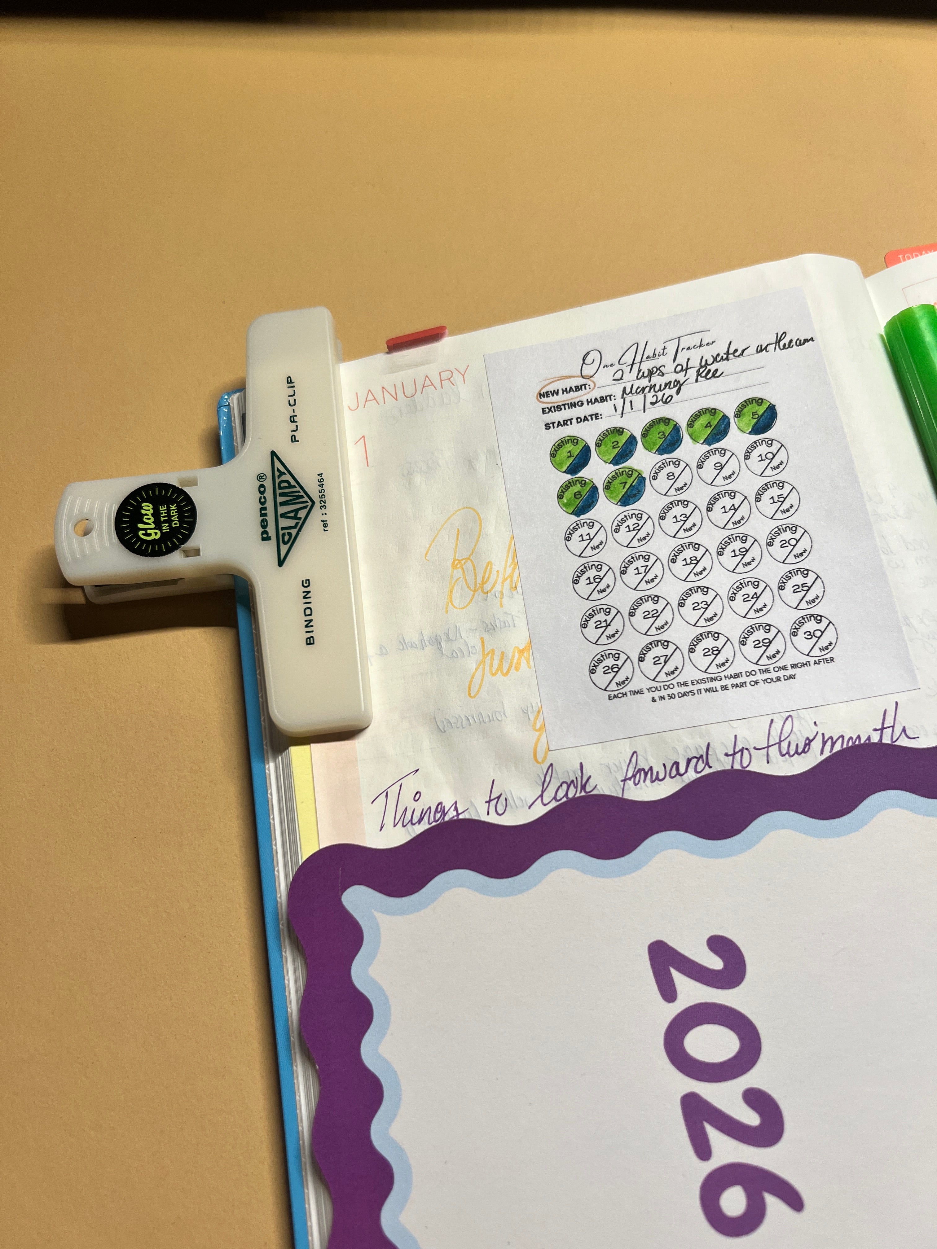 Calendar with 2026 highlighted and a document holder on a beige surface