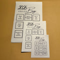 2026 Analog Bingo sticker sheets in three on a brown background
